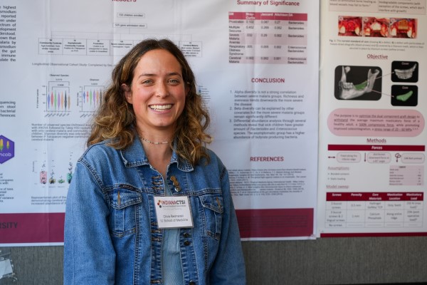Olivia Bednarski poses with her poster highlighting her research.